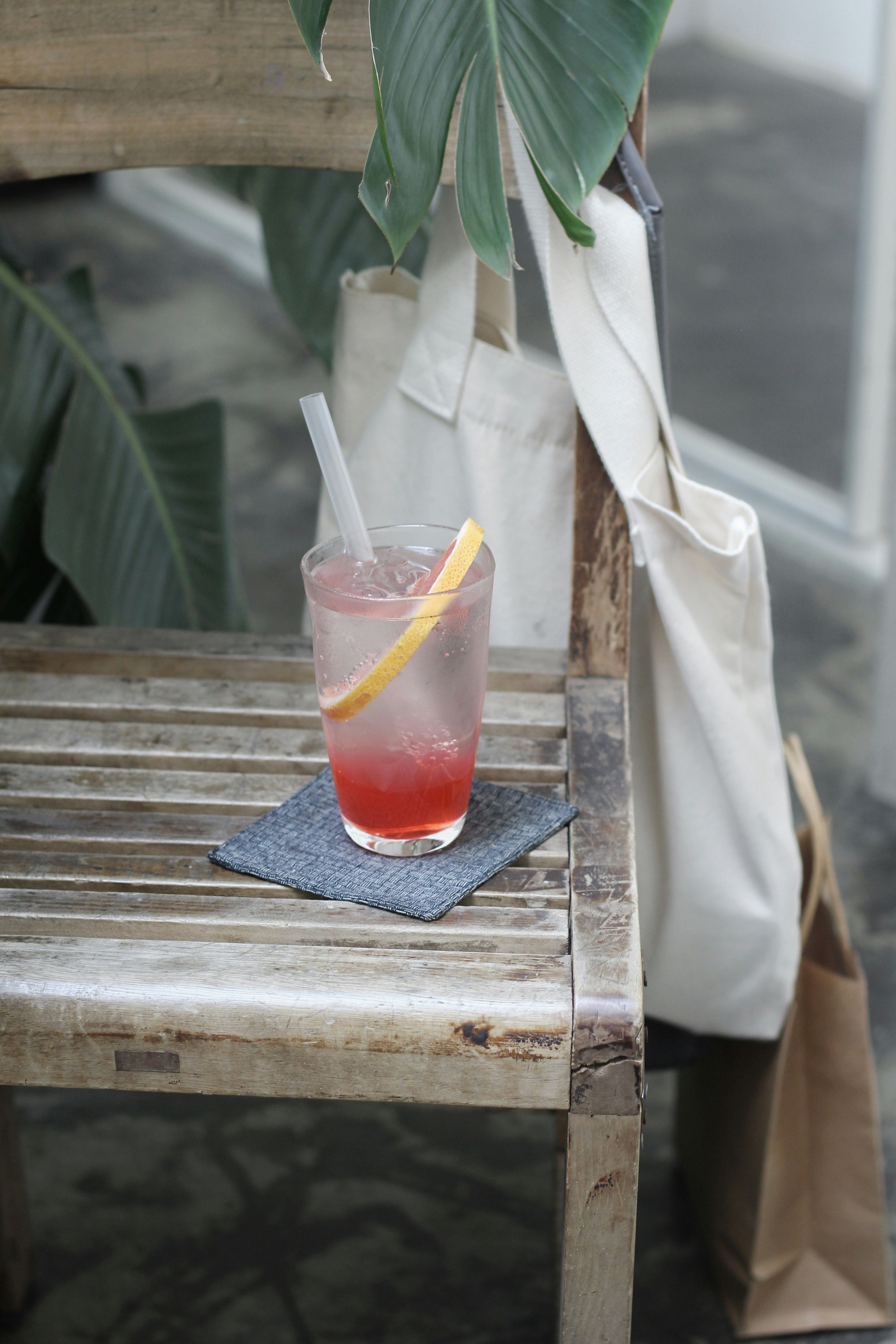 clear glass cup filled with liquid on wooden bench